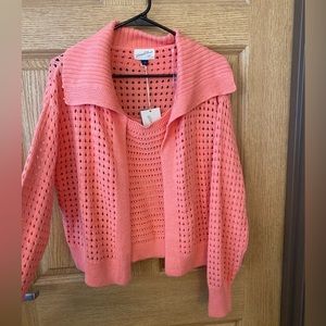 Peach colored tank top and sweater